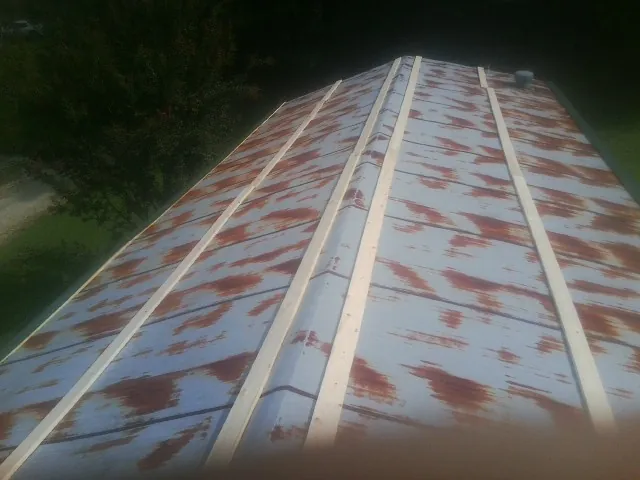 Rusted metal roof panels with new wood purlins before replacement — Storm Damage Roof Repair in Cuyahoga Falls by Roofing Brothers