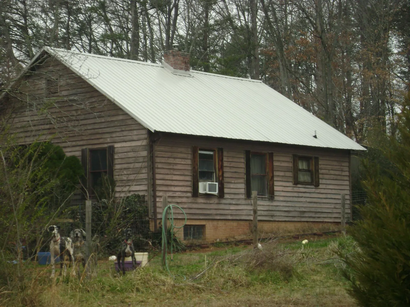 White metal roof on an old wood sided farmhouse, from a Metal Roof Installation job in Cuyahoga Falls